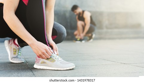 Man and woman tying shoelaces before running outdoor, panorama, free space