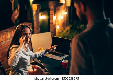 Man And Woman Using Laptop Computer Outdoor In Backyard Night Scene