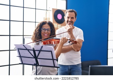Man And Woman Violinist Having Violin Lesson At Music Studio