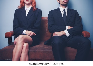 Man And Woman Waiting To Enter A Job Interview