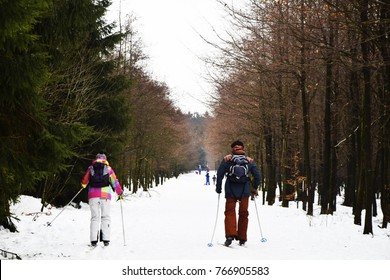 Man And Woman Walking On Snow In Winter