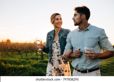 Man and woman walking and talking outdoors. Couple spending time together at vineyard. - Powered by Shutterstock