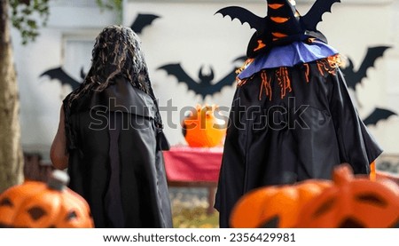 Man and woman wearing black color halloween costume celebrate. Wide Halloween party art design