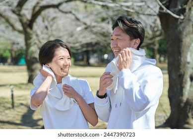 Man and woman wiping sweat after exercising - Powered by Shutterstock