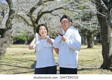 Man and woman wiping sweat after exercising - Powered by Shutterstock