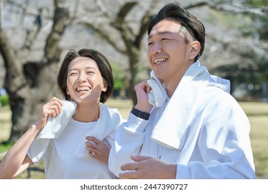 Man and woman wiping sweat after exercising - Powered by Shutterstock