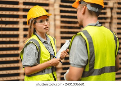 Man and woman workers with clipboard discussing working and checking stock inventory wood plank material for making wooden pallet products at warehouse industrial factory, woodwork production - Powered by Shutterstock