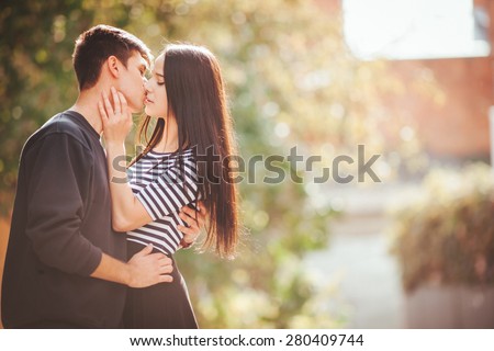 Man and woman or young couple walking  on the sunny city