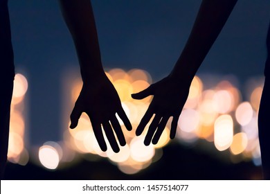 Man and woman's hands coming together facing the city night lights. People, love and relationships concept.  - Powered by Shutterstock