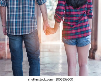 man and women holding hand together, family concept, warm feeling between man and woman stand together in an abandoned building. and hand hold for power up heart energy, serious and worry feeling. Fil - Powered by Shutterstock