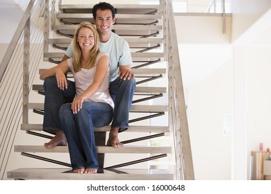 man and women sitting on stairs indoors - Powered by Shutterstock