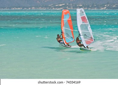 Man And Women Windsurfing In The Lagoon