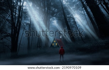 Man in the woods observing a cabin