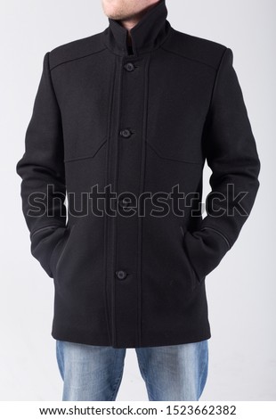 A man with a woolen coat on a white background. The guy in the autumn-spring jacket. Demi-season men's clothing. Comfortable casual outerwear for men.