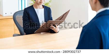 A man in work clothes and an interviewer