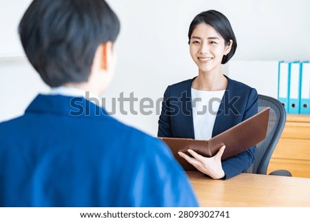A man in work clothes and an interviewer