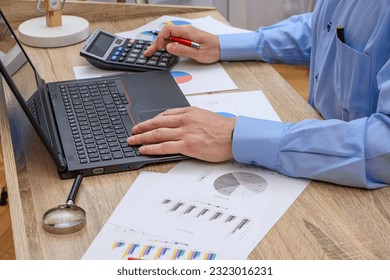 Man at work at desk, accountant - Shutterstock ID 2323016231