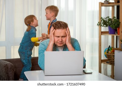 Man work from home with kids jumping around. Stress and noise. Father with head in hands. 