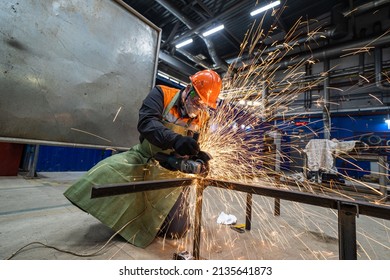 Man Work In Home Workshop Garage With Angle Grinder, Goggles And Construction Gloves, Sanding Metal Makes Sparks Closeup, Diy And Craft Concept