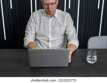 Man work at laptop computer at office desk.