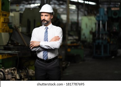 Man at work. Mechanical Engineer Bearded man in Hard Hat  in Heavy Industry Manufacturing Facility. Professional Engineer Operating lathe Machinery - Shutterstock ID 1817787695