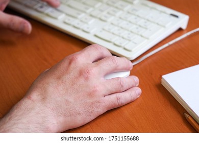 Man work in office, keyboard, computer mouse and a stack of papers on the table. Workplace