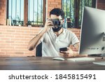 man work on the digital camera in office