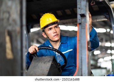 Man At Work. Professional Operation Engineering. Young Asian Worker Forklift Driver Wearing Safety Goggles And Hard Hat Sitting In Vehicle In Warehouse