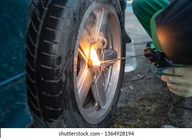 Man work with welding. Mechanical tools for auto service and car repair in Car repair shop and Worker repairing car.Car wheel repair - Powered by Shutterstock