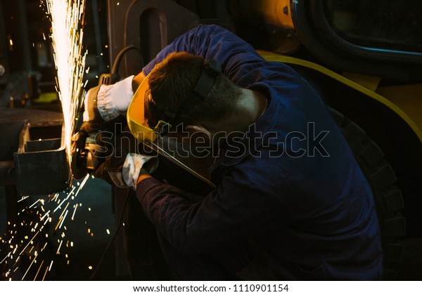 Man work with welding.Repairs the metal structure in\
the car.