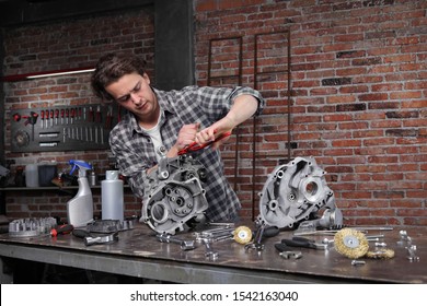 Man Work With The Wrench, Repair And Cleaning Engine Parts On The Workbench In Home Garage Workshop, Diy Concept