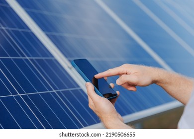 Man Worker Analyzing Data On Phone Background Solar Panel Power Station.