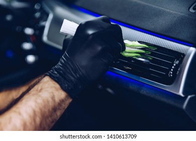 Man Worker In Car Wash Cleaning Car Air Vent. Car Detailing