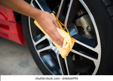 Man Worker Cleaning Car's Alloy Wheels On A Car Wash