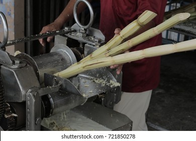 Man Worker Extract Cane Juice - Powered by Shutterstock