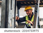 Man worker at forklift driver happy working in industry factory logistic ship. Man forklift driver in warehouse area.	Forklift driver sitting in vehicle in warehouse