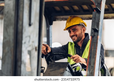 Man worker at forklift driver happy working in industry factory logistic ship. Man forklift driver in warehouse area.	Forklift driver sitting in vehicle in warehouse - Shutterstock ID 2314733975