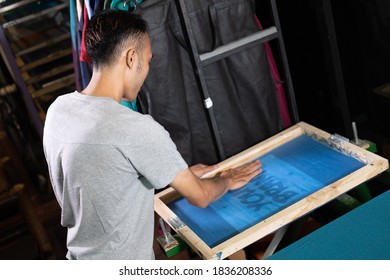 Man Worker Hold Onto Silk Screen Frames When Preparing Screen Printing Film