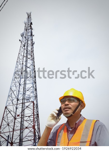 A man worker is on the phone with the manager at
contruction site
