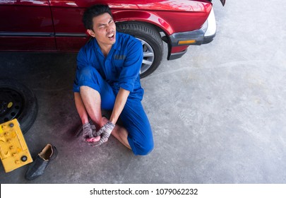 Man Worker With Toe Injury In Garage,
Concept Of Accident At Work