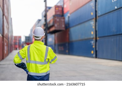 Man worker using walkie talkie to communication with colleague at container yard. Container yard warehouse, Cargo Shipping Import and Export industry. Logistic shipping yard business.