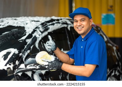 Man worker washing car service with foam and sponge. Car wash cleaning wipe station. Employees clean a vehicle professionally. - Powered by Shutterstock