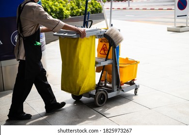 Man Worker  Working With Janitorial, Cleaning Equipment And Tools For Floor Cleaning.