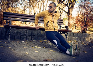 Man working back pushups on bench. 