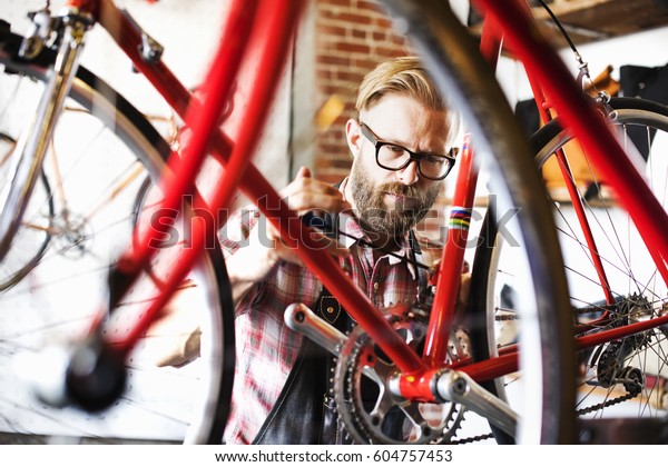 A man working in a\
bicycle repair shop