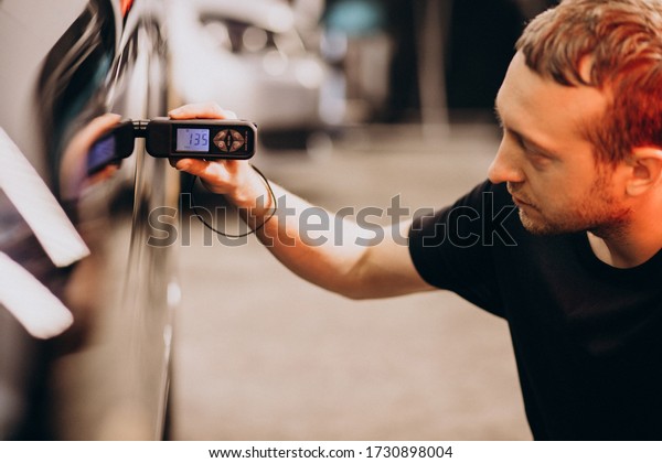 Man working at a\
car wash detailing station