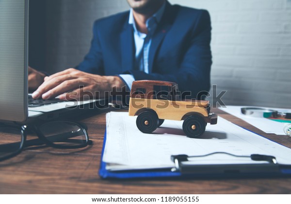 man working computer with\
car