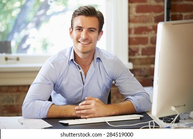 Man Working At Computer In Contemporary Office