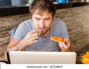 Man Working At The Computer And Eating Fast Food. Unhealthy Lifestyle.
