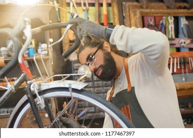 Man working in cycle repair shop - Powered by Shutterstock